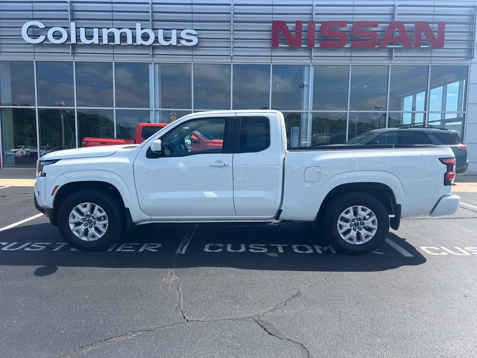 2024 Nissan Frontier SV in White — front three-quarter view