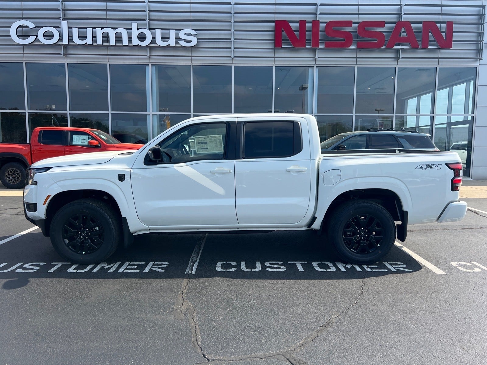 2026 Nissan Frontier SV in White — front three-quarter view