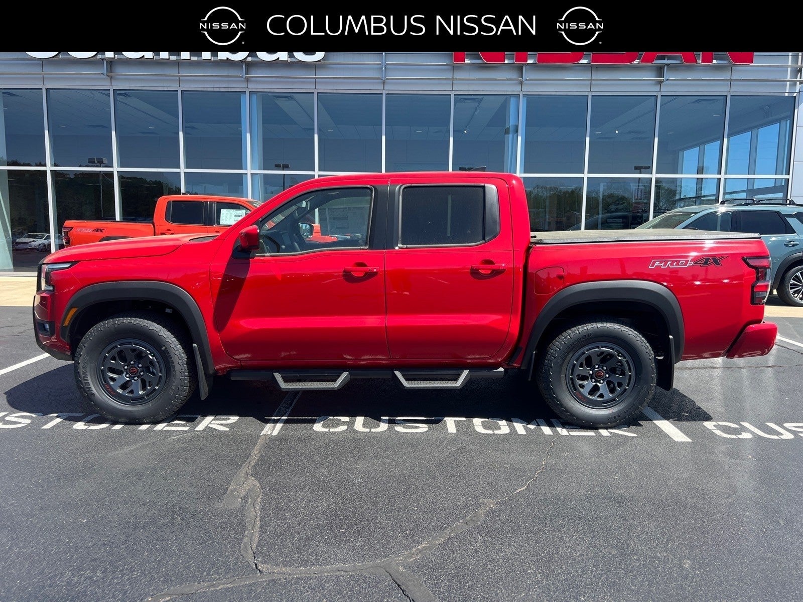 2026 Nissan Frontier PRO-4X in Red — front three-quarter view