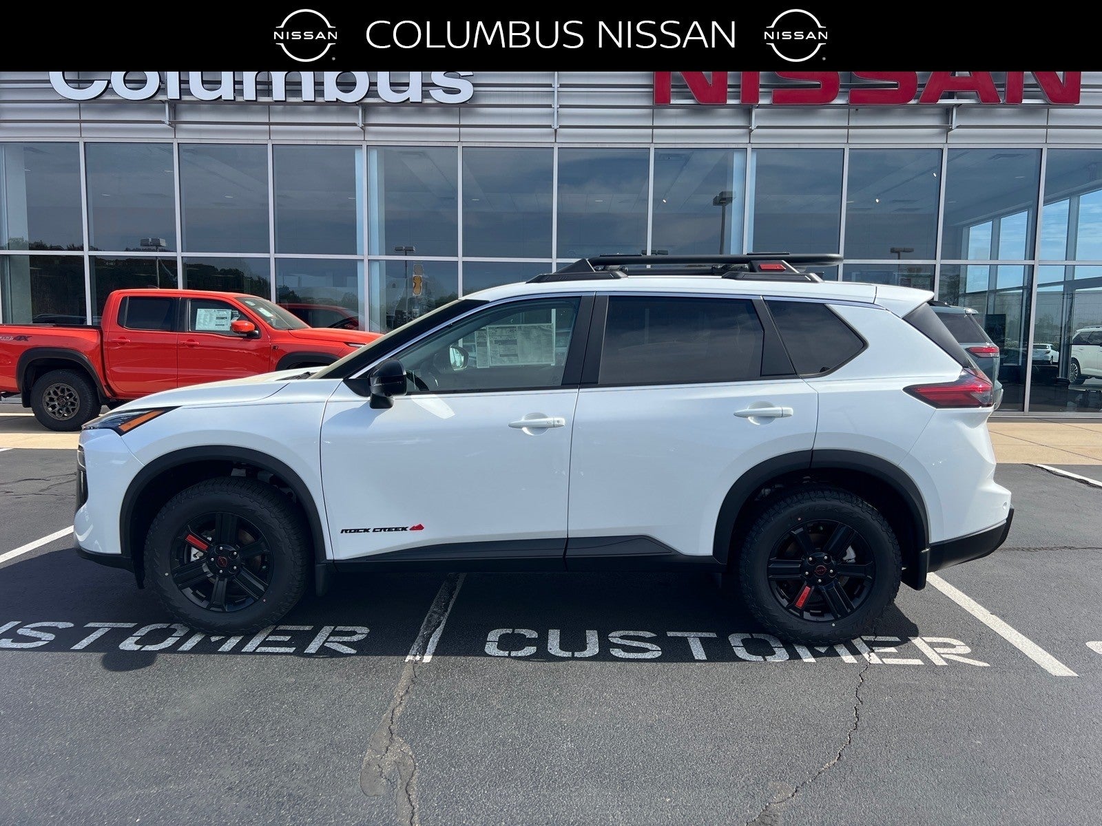 2026 Nissan Rogue Rock Creek in White — front three-quarter view