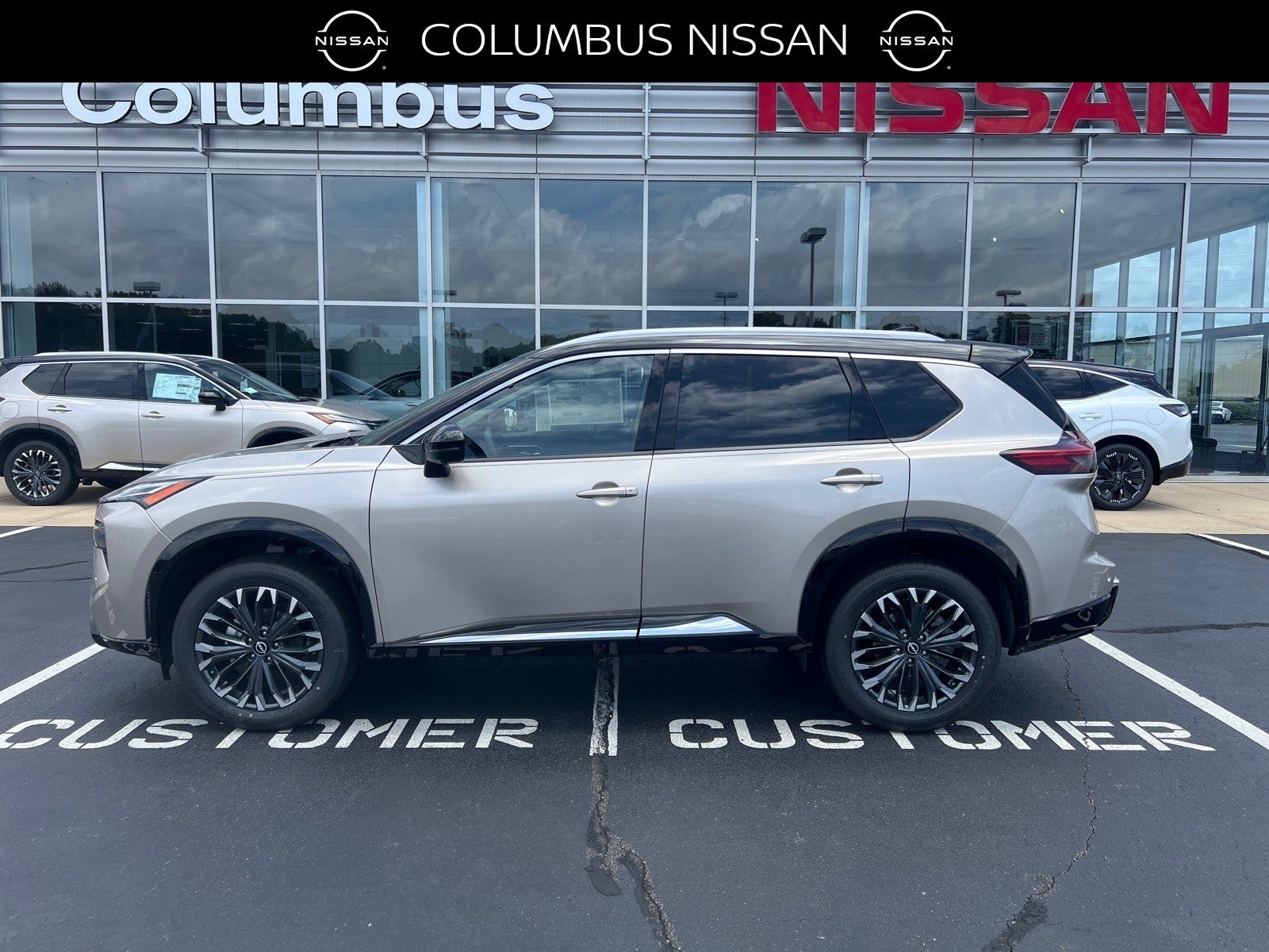 2026 Nissan Rogue Platinum in Gold — front three-quarter view