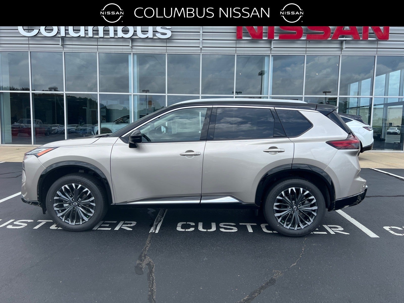2026 Nissan Rogue Platinum in Gold — front three-quarter view